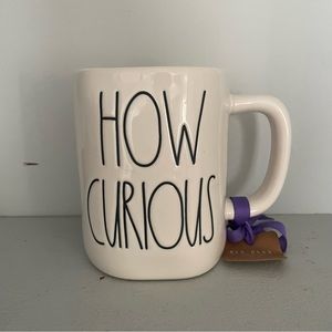 Rae Dunn Disney’s Alice in Wonderland mug. How Curious Cheshire Cat mug.